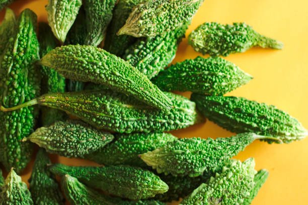 Cutting bitter melon,bitter Gourd,momordica Charantia in group freshly harvested at agricultural farm in india,copy space with selective focus
